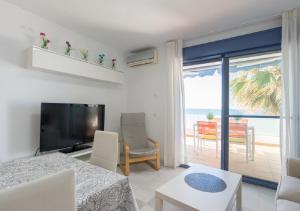 a living room with a view of the ocean at Apartamentos Varadero Sea View in Cala del Moral