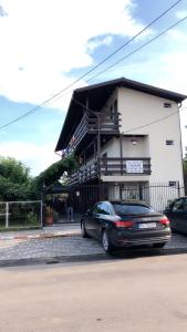 a black car parked in front of a building at Estelle in Costinesti