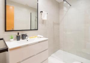 a white bathroom with a sink and a shower at Apartamentos Varadero Sea View in Cala del Moral