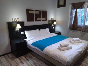 a bedroom with a large bed with two towels on it at Villa Azur Cap d'Ail in Cap d'Ail