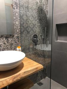 a bathroom with a sink and a shower at Hotel Denta in Vlorë +41 photos