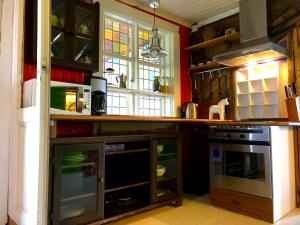 a kitchen with a counter with a stove and a window at Station Villa Vimmerby in Vimmerby