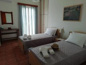 A bed or beds in a room at Melissani House