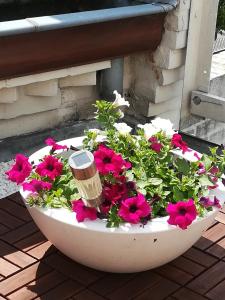 a flower pot with flowers in it on a patio at Halte 46 Weert in Weert