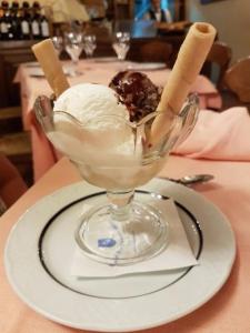 a glass bowl filled with ice cream and whipped cream at Hotel Tres Coronas de Silos in Santo Domingo de Silos