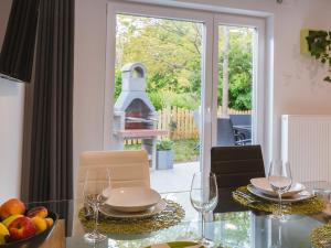 a dining room with a glass table with a bowl of fruit at Blue Door in Lesce