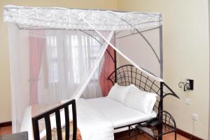 Postel nebo postele na pokoji v ubytování Rates Hotel Mbale