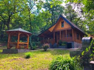 a cabin in the woods with a gazebo at Brvnara Vršac in Vršac