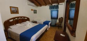 a bedroom with a bed and a chair and window at Beb Eclissi in Fontane Bianche