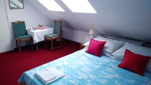 a bedroom with a bed and two chairs and a table at Rooms IVKA in Plitvička Jezera
