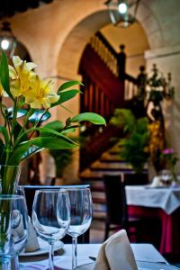 
a vase filled with flowers sitting on top of a table at Hotel Condes de Castilla in Segovia
