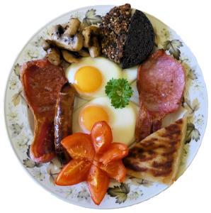 a plate of breakfast food with eggs bacon and mushrooms at Buttonboss Lodge B&B in Pitlochry