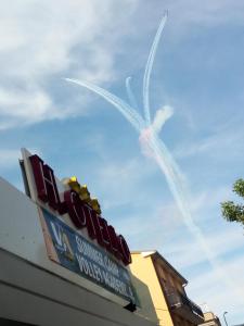 a sign for a fast food restaurant with a plane in the sky at HOTEL OTELLO in Punta Marina