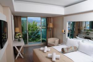 a bedroom with a large bed and a large window at Alesta Yacht Hotel in Fethiye