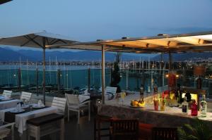 a patio area with tables, chairs and umbrellas at Alesta Yacht Hotel in Fethiye