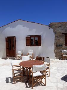 a wooden table and chairs in front of a building at Teacher's House in Maroni