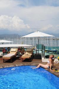 a man sitting in a pool next to a pool table at Alesta Yacht Hotel in Fethiye