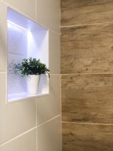 a bathroom with a potted plant in a window at Smart Home Žilina in Žilina