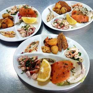 a group of plates of food on a table at Hotel Villa Principe in San Nicola Arcella