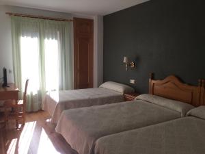 Posteľ alebo postele v izbe v ubytovaní Hotel Cinco Castaños