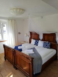 a bedroom with a large bed with blue and white pillows at Ca' Flora in Nerezine
