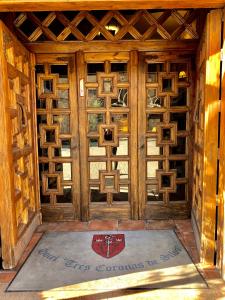 a door that is open to a room with a wooden floor at Hotel Tres Coronas de Silos in Santo Domingo de Silos