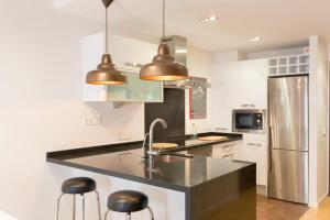 A kitchen or kitchenette at POC A POC SUITES