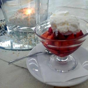 a bowl of strawberries and ice cream on a plate at Hotel Villa Principe in San Nicola Arcella