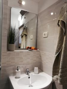 a bathroom with a sink and a mirror at Apartments 4U in Omišalj +34 photos