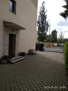 a patio with a bench next to a building at Eleven Pokoje in Gdynia +15 photos
