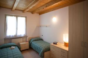 Ένα ή περισσότερα κρεβάτια σε δωμάτιο στο RESIDENCE VILLA ARANCI