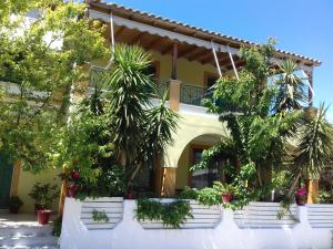 a house with potted plants in front of it at Lenia Studios in Kalamitsi
