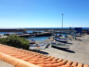 a group of boats docked at a marina at Farol da Vila in Vila Franca do Campo