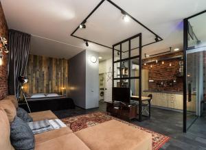 a living room with a couch and a bedroom at Loft in Arcadia in Odesa