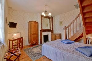 a bedroom with a bed and a fireplace at Dolwin in Argelès-Gazost