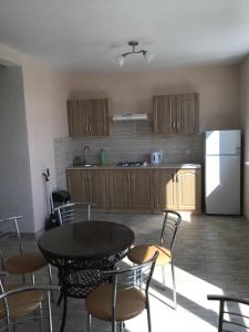 a kitchen with a table and chairs and a refrigerator at Адмирал 3. Вилла in Koblevo +19 photos