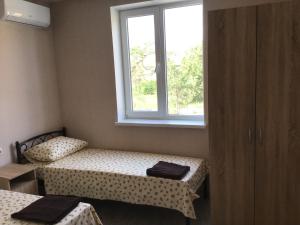 a room with two beds and a window at Адмирал 3. Вилла in Koblevo