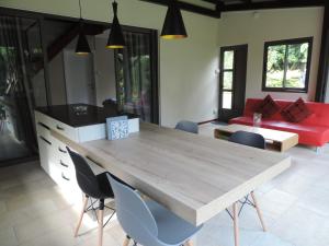 a dining room with a wooden table and chairs at Luxury Cosy Guesthouse in Pamplemousses Village