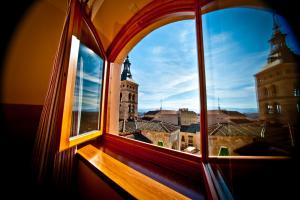 
a window with a view of a city at Hotel Condes de Castilla in Segovia
