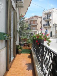 a balcony with potted plants on a building at Il mare in un Boccaccio in Polignano a Mare