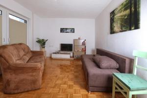 a living room with two chairs and a couch at Apartma Dolinar in Gorenja Vas
