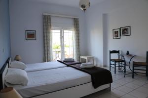 a bedroom with a large bed and a window at Aris Apartments in Gerani