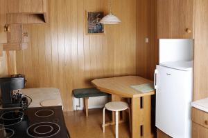 a small kitchen with a small table and a refrigerator at Apartma Dolinar in Gorenja Vas