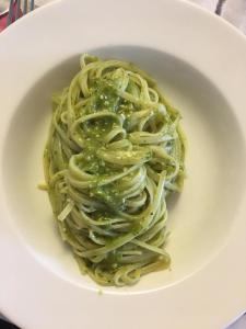 a white bowl filled with pasta with green sauce at Hotel Saint Tropez in Riccione