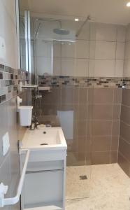 a bathroom with a shower and a sink and a mirror at Studio d'environ 20m2, piscine, vue mer, pour 2 personnes in Marseille