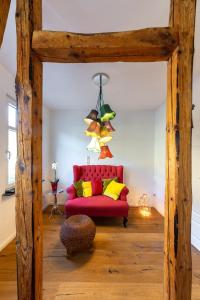 a living room with a red couch and yellow pillows at HAUS RHEINLEBEN in Boppard