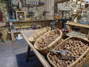 three baskets of potatoes on a table in a store at La Ferme Les Mamours in La Bastide-lʼÉvêque +17 photos