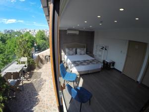 a bedroom with a bed and chairs on a balcony at Meydan Suites in Istanbul