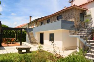 a house with a staircase and a patio at Casa da Romeira in Ponte de Lima
