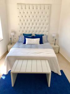 a bedroom with a large bed with a large headboard at Sky House Amalfi Coast in Scala